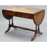 A reproduction mahogany drop-leaf writing table, inset gilt-tooled brown leather, fitted two