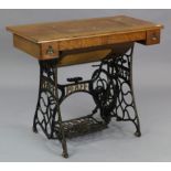 An early 20th century Pfaff treadle sewing machine in oak case, & on cast-iron stand, 37” wide.