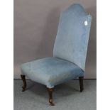 A Georgian-style nursing chair, on short cabriole legs & pad feet with ceramic castors.