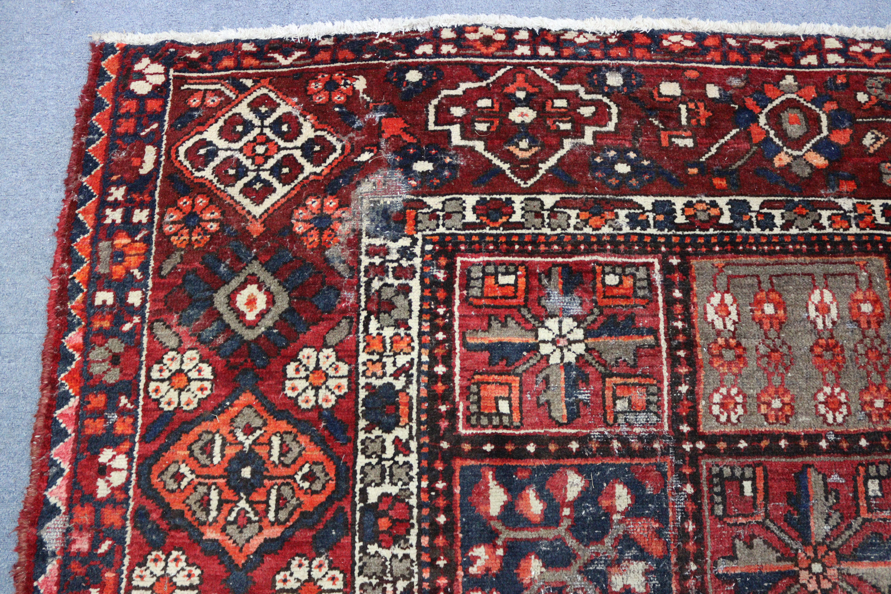 A Persian pattern carpet of crimson & deep blue ground, & with all-over repeating multi-coloured - Image 4 of 6