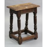 An 18th century-style oak joint-stool on four baluster-turned legs with plain stretchers, 17½”