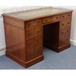 A Victorian mahogany pedestal desk inset gilt-tooled green leather, fitted with an arrangement of