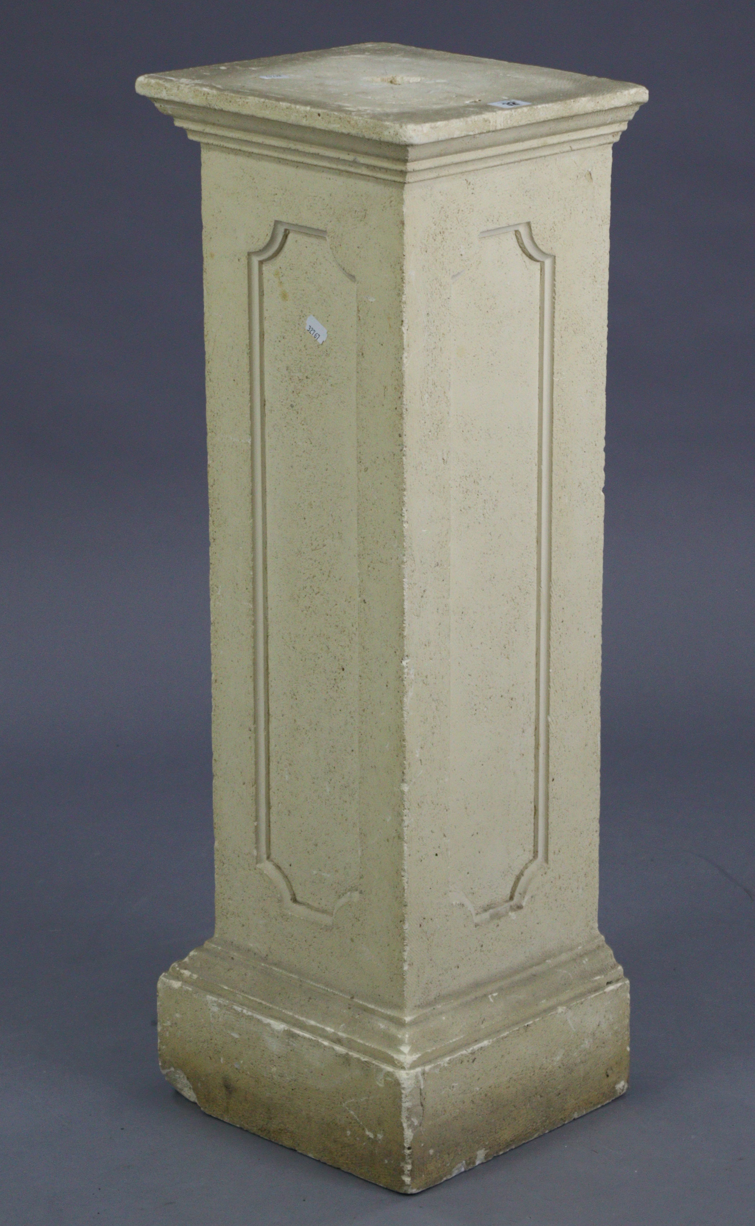 A reconstituted stone square pedestal, 11” wide x 35¼” high.