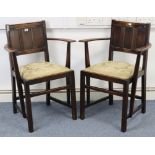 A pair of oak carver dining chairs with panelled backs, padded drop-in-seats, & on chamfered