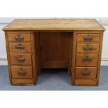 A pitch pine pedestal desk fitted four long graduated drawers to each pedestal, & with cupboard to