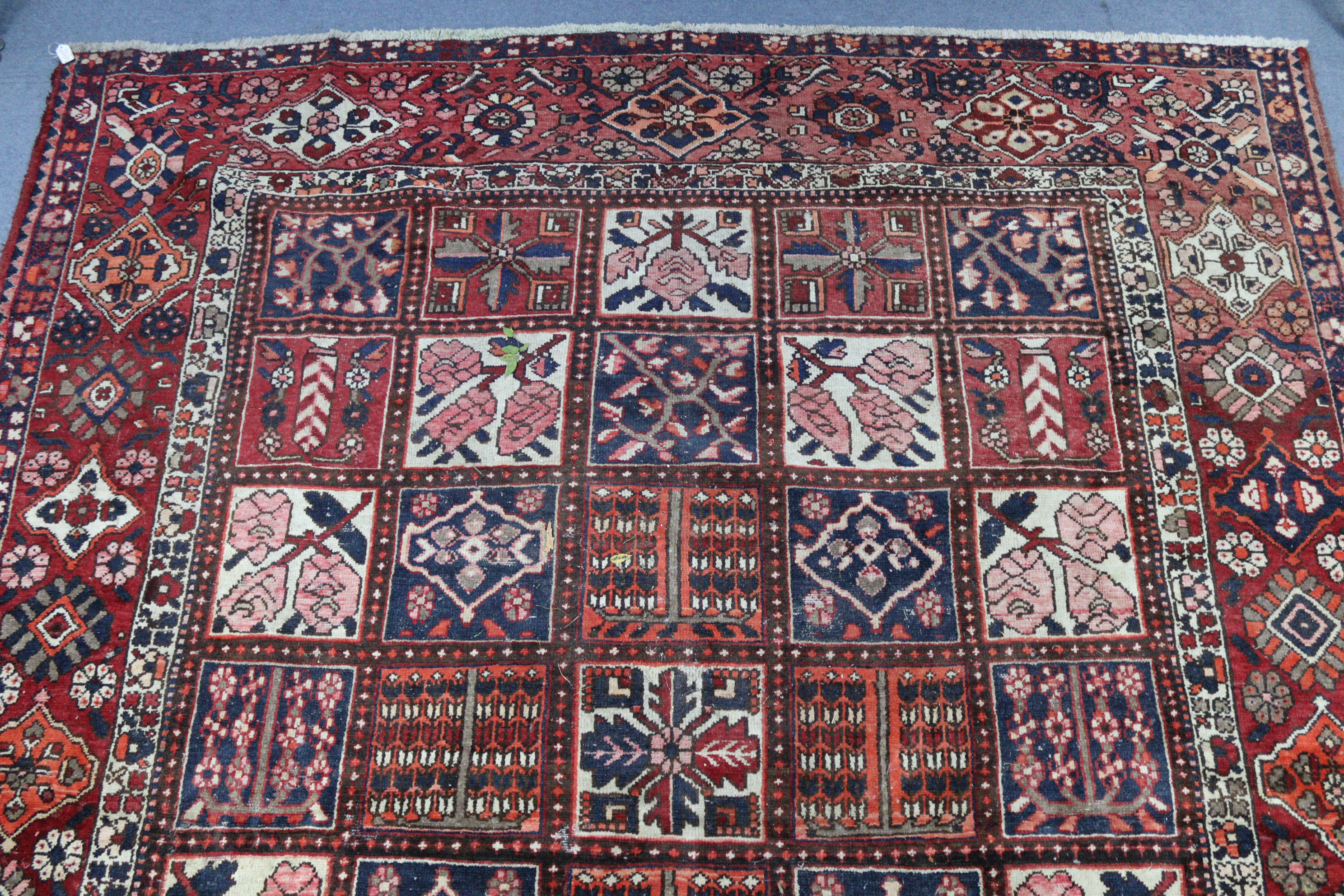 A Persian pattern carpet of crimson & deep blue ground, & with all-over repeating multi-coloured - Image 2 of 6