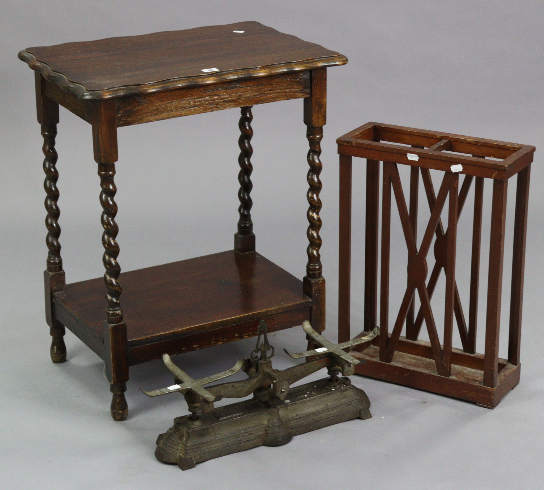 A 1930’s oak rectangular two-tier occasional table on barley-twist legs & turned feet, 22¾” wide;