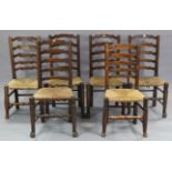 A matched set of six oak ladder-back dining chairs with woven rush seats, & on turned legs with