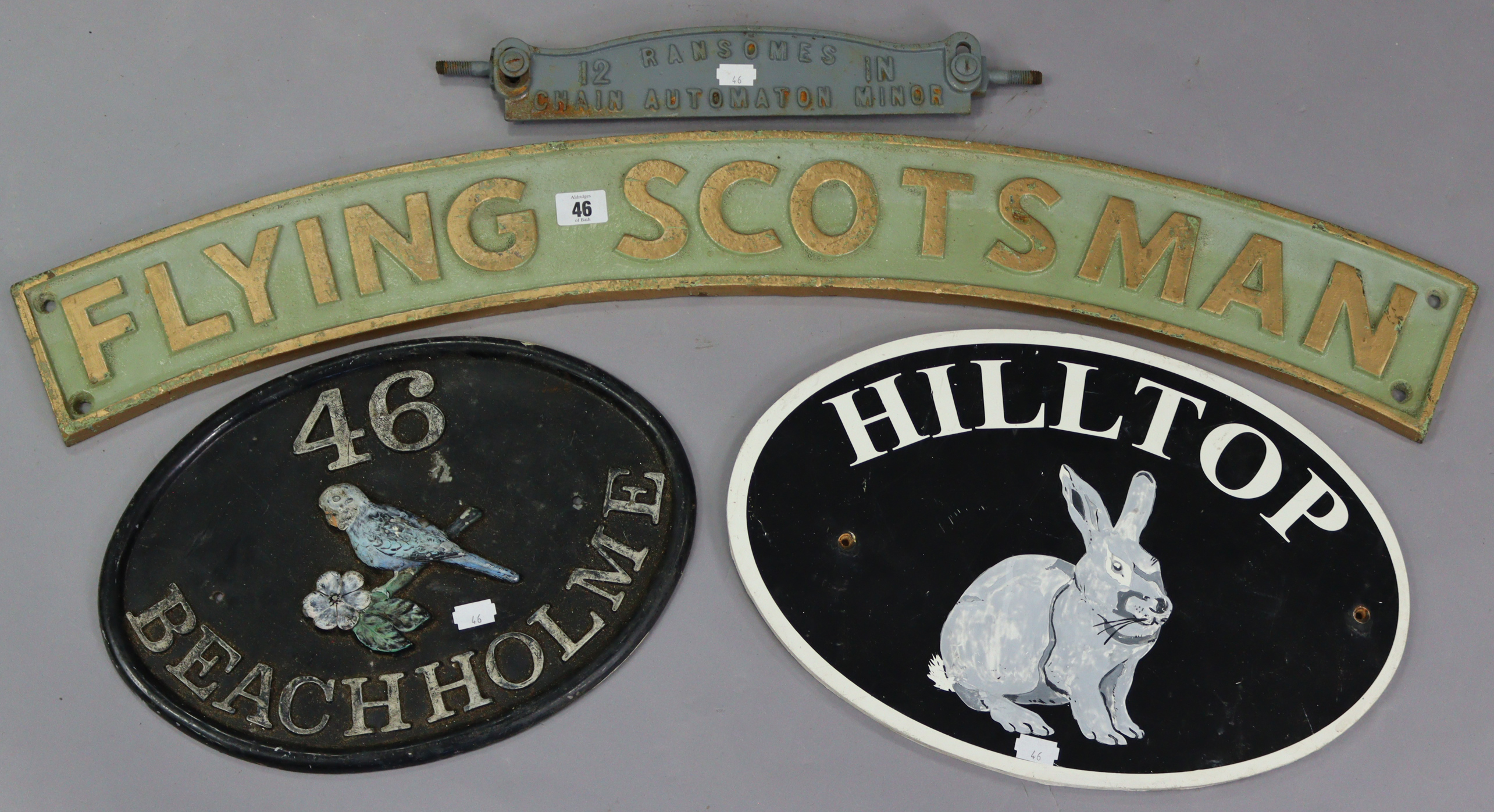 A reproduction painted cast-iron locomotive name plate “FLYING SCOTSMAN”, 35½” long; together with