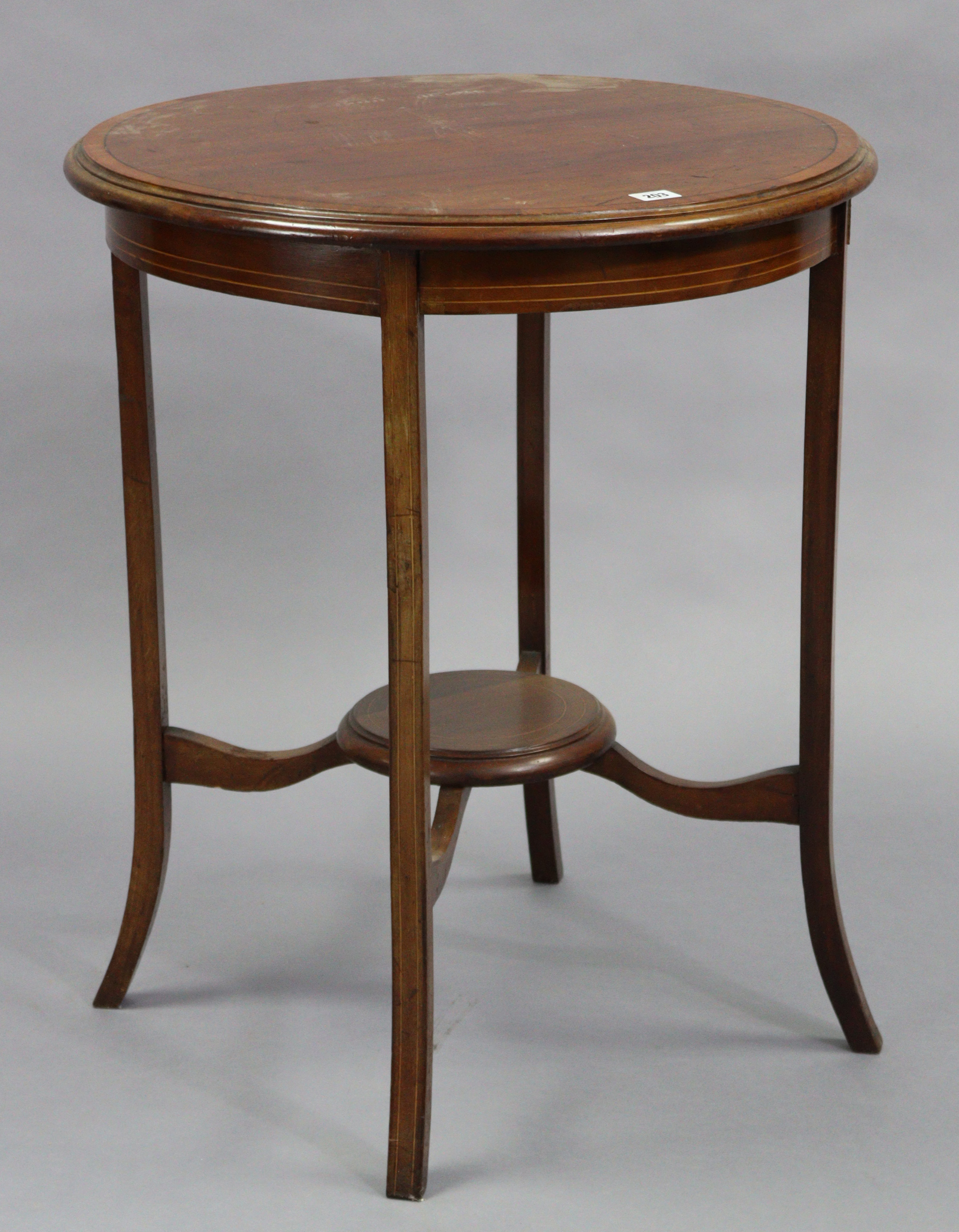 An Edwardian inlaid-mahogany circular two-tier occasional table on four shaped legs, 24” diameter