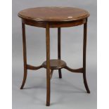 An Edwardian inlaid-mahogany circular two-tier occasional table on four shaped legs, 24” diameter