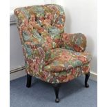 A buttoned-back easy chair upholstered multi-coloured floral material, & on short cabriole legs &