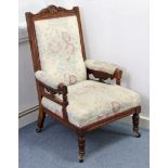 A late Victorian carved oak frame ladies armchair with padded seat & back, & on short turned legs