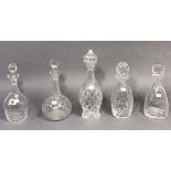 Five various heavy cut-glass decanters.