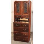 A late Victorian mahogany wardrobe section enclosed by pair of carved panel doors above two