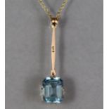 A synthetic aquamarine pendant, the rectangular-cut stone approximately 2.5 carats, set to a 9ct. go