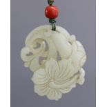 An early 20th century Chinese pale celadon jade pendant, carved & pierced in the form of a