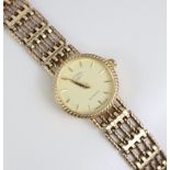 A Rotary 9ct. gold ladies’ bracelet watch, the small circular champagne dial with gold baton