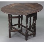 A late 17th century oak gate-leg table, the oval top with drop leaves, fitted end drawer, & on