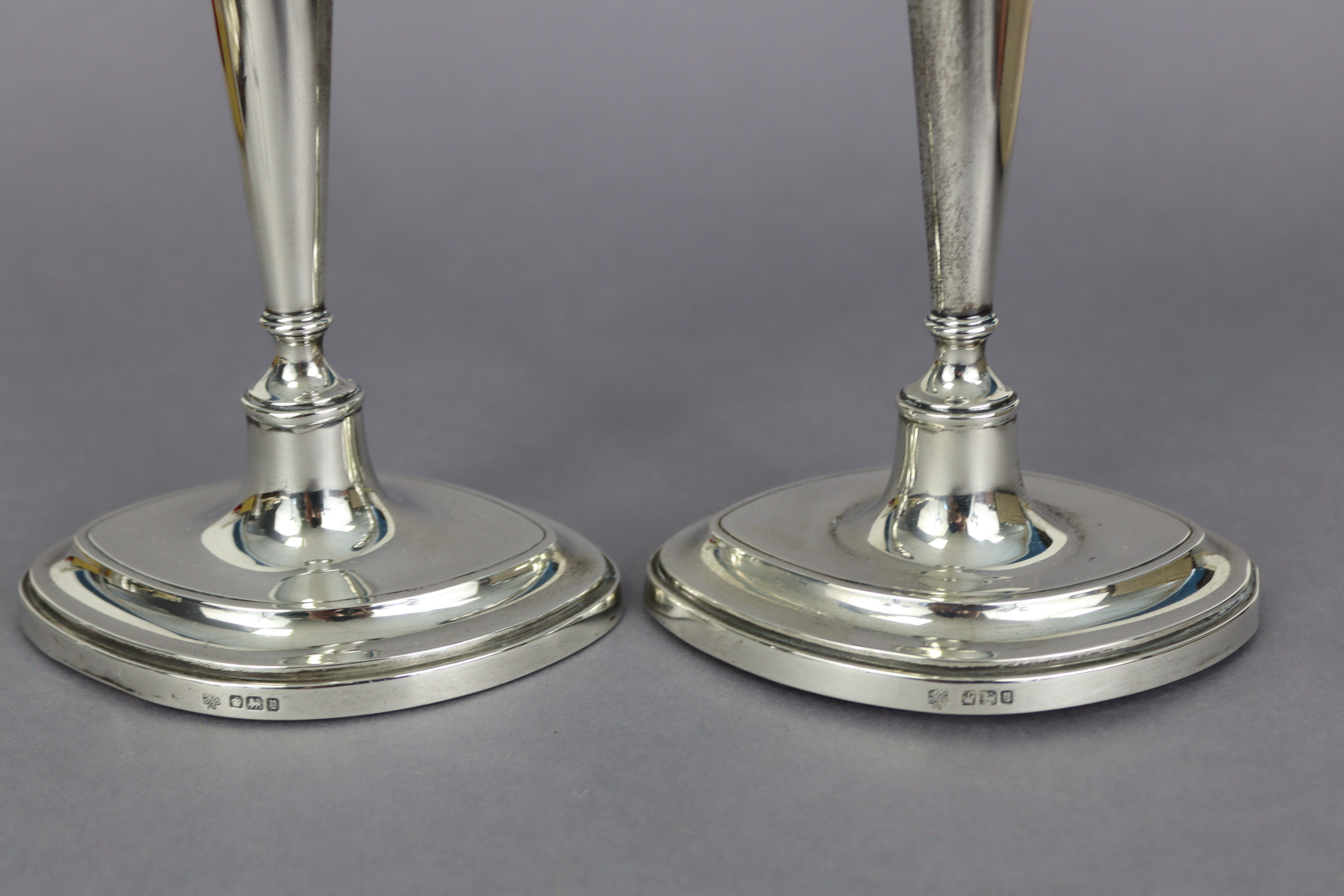 A pair of George V silver candlesticks in the late 18th century style, with vase-shaped nozzles, - Image 2 of 3