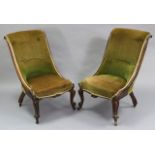 A pair of early Victorian mahogany nursing chairs with curved buttoned backs & sprung seats