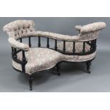 A Victorian conversation seat with ebonised S shaped scroll frame, having padded seat, back &