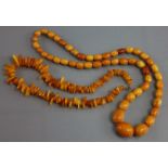 A butterscotch amber necklace of graduated oval beads (53 gm); & a similar necklace of