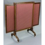 An early Victorian carved rosewood extendable fire screen inset floral silk damask, each side with