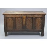 A late 17th century joined oak coffer, the four-panel front profusely carved with the tree of life