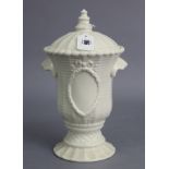 A Belleek porcelain large two-handled ribbed vase & cover with laurel wreath oval cartouche, on