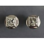 A PAIR OF DIAMOND EAR-STUDS, the Princess-cut stones weighing approx. 1.4 carats each, in plain