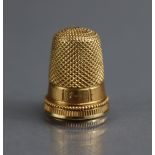 A GOLD THIMBLE with engraved inscription “Grace”, ¾” high, un-marked (6.8gm); in TIFFANY & Co.