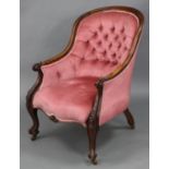 A Victorian carved rosewood frame buttoned-back ladie’s armchair with downswept padded arms,