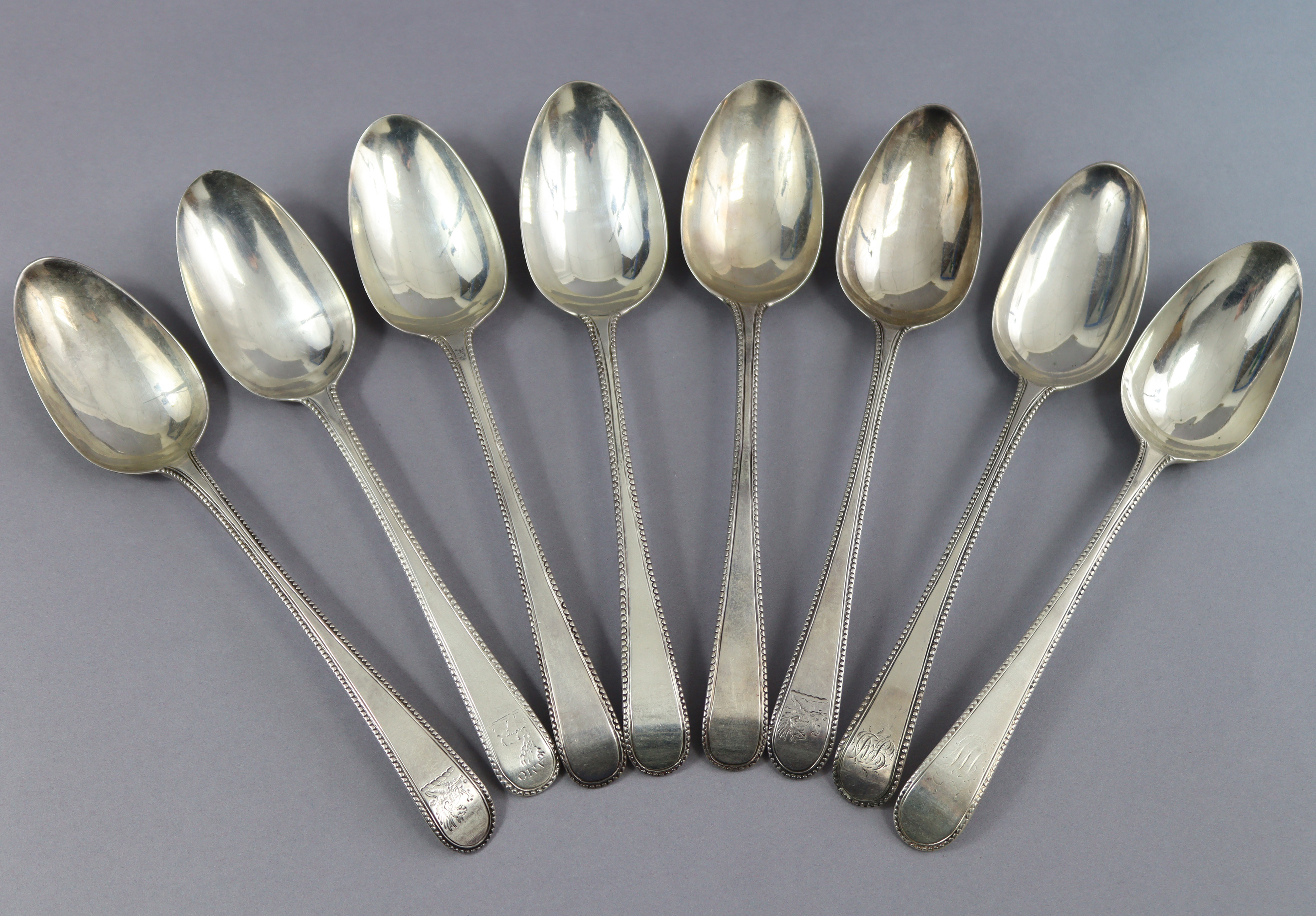 Eight George III silver Old English Bead pattern table spoons; London 1777 by Thos. Northcote, two