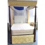 A GEORGE III MAHOGANY FOUR-POSTER BED, with turned, reeded, & leaf-carved slender baluster end –