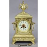 A 19th century French gilt-brass mantel clock with urn surmount & ring side handles, the 3¾” diam.