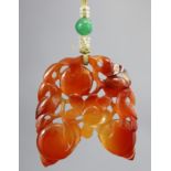 An early 20th century Chinese amber-coloured jade pendant, carved & pierced in the form of