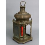 An antique copper hall lantern with embossed armorial to the hinged door; 8” wide x 18” high.