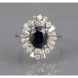 A SAPPHIRE & DIAMOND RING, the oval-cut sapphire approx. 2 carats set within a radiating border of