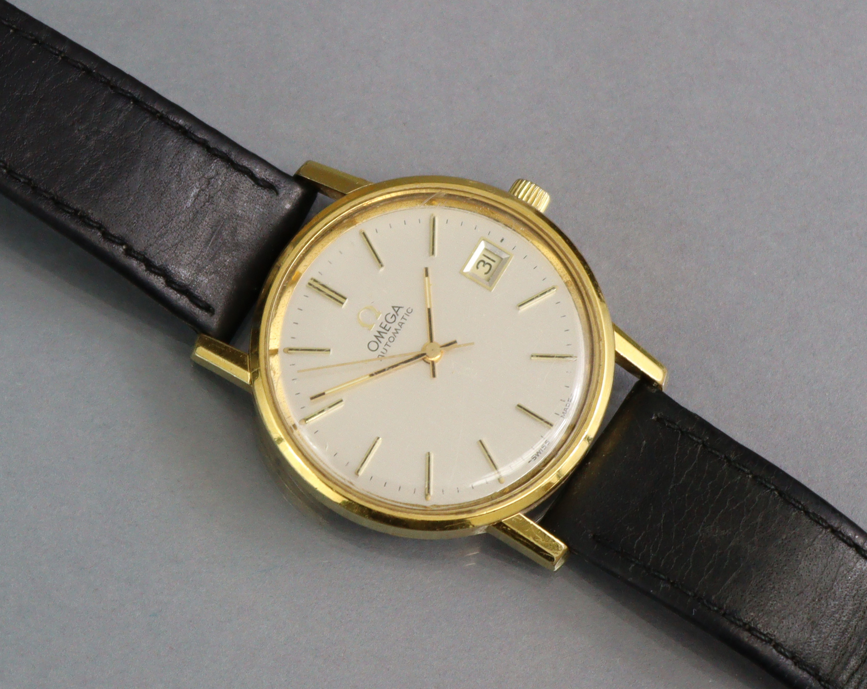 An Omega Automatic gent’ wristwatch, the circular silvered dial with gilt baton numerals, date