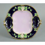 A George Jones majolica strawberry dish with shaped pink-ground centre, the wide deep blue border