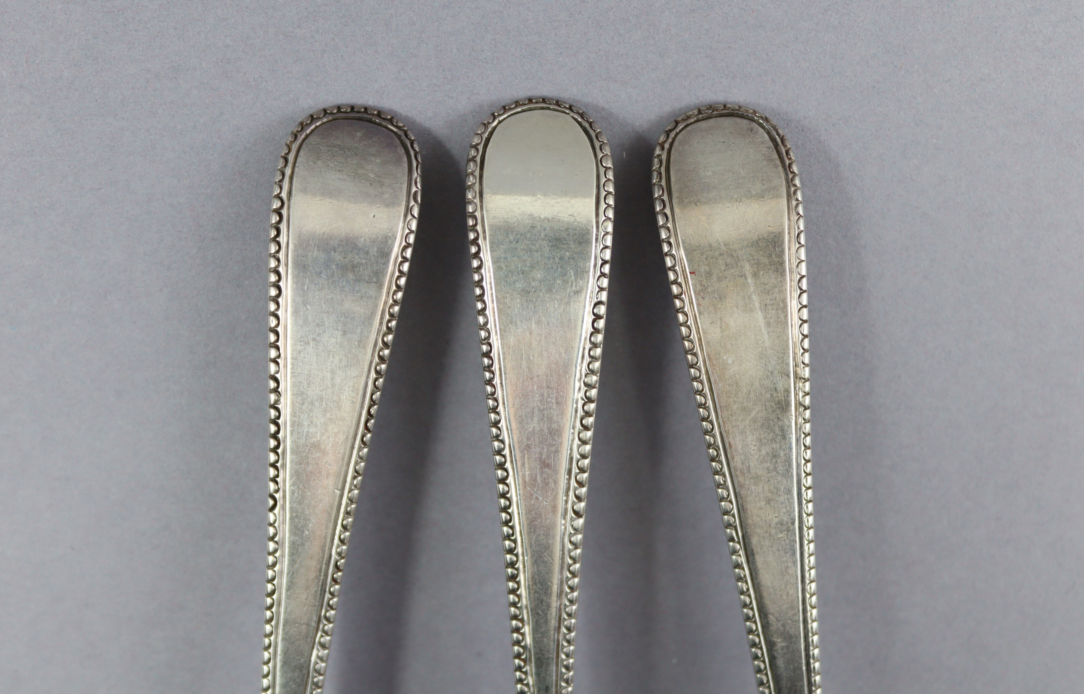 Eight George III silver Old English Bead pattern table spoons; London 1777 by Thos. Northcote, two - Image 2 of 7