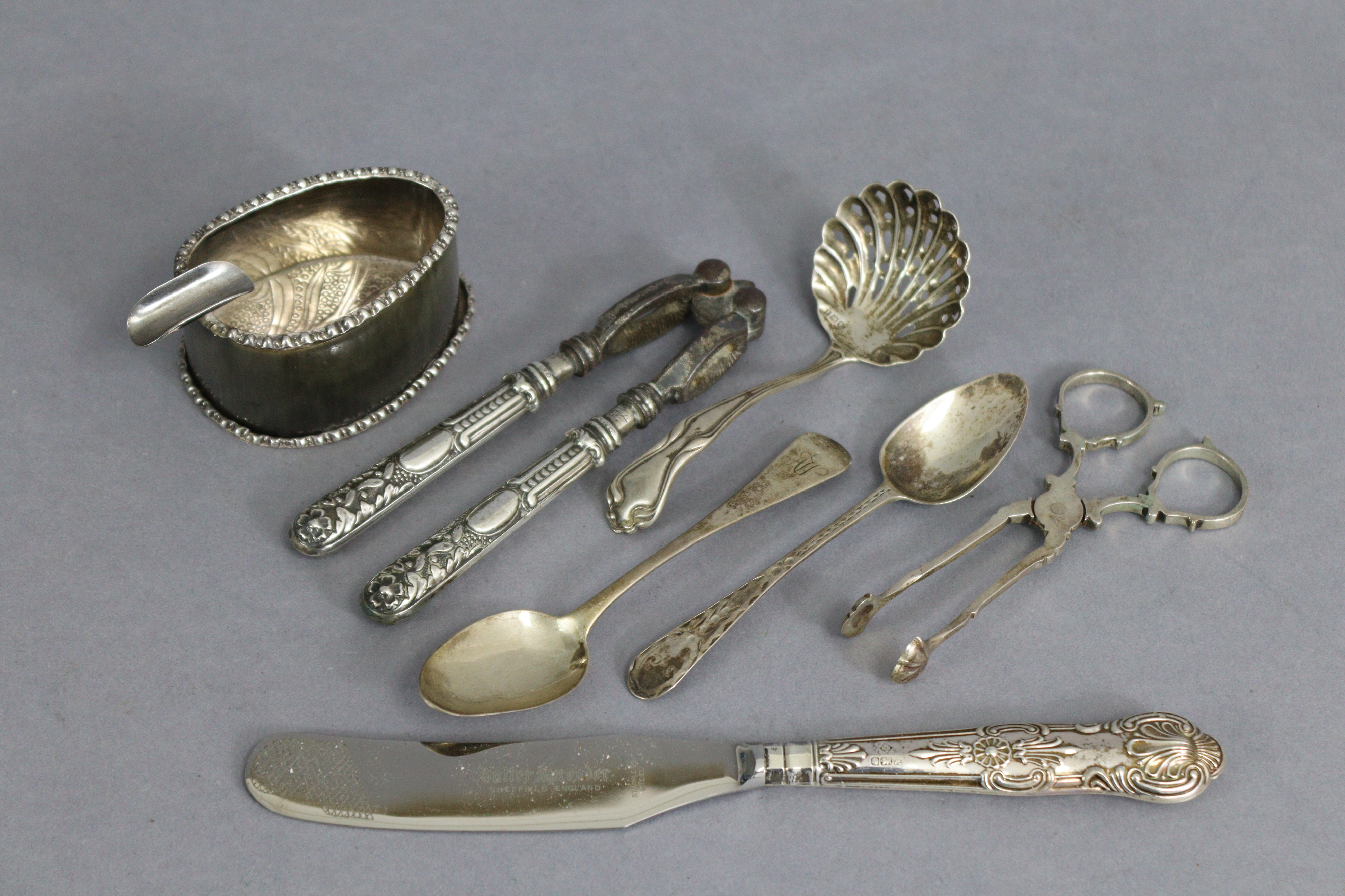 A pair of 18th century style silver scissor-action sugar nips, Birmingham 1977; a sugar-sifter