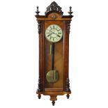 A late Victorian Vienna regulator wall clock in walnut veneered case with carved pediment & turned