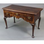 An 18th century oak lowboy, the rectangular top with moulded edge & rounded corners, fitted three