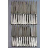 Twelve Old English Bead pattern steel table knives, & twelve matching dessert knives, with loaded