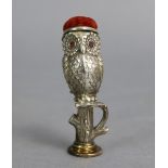 A novelty silvered metal desk-seal/pin-cushion in the form of an owl perched on a tree; 3¼” high.