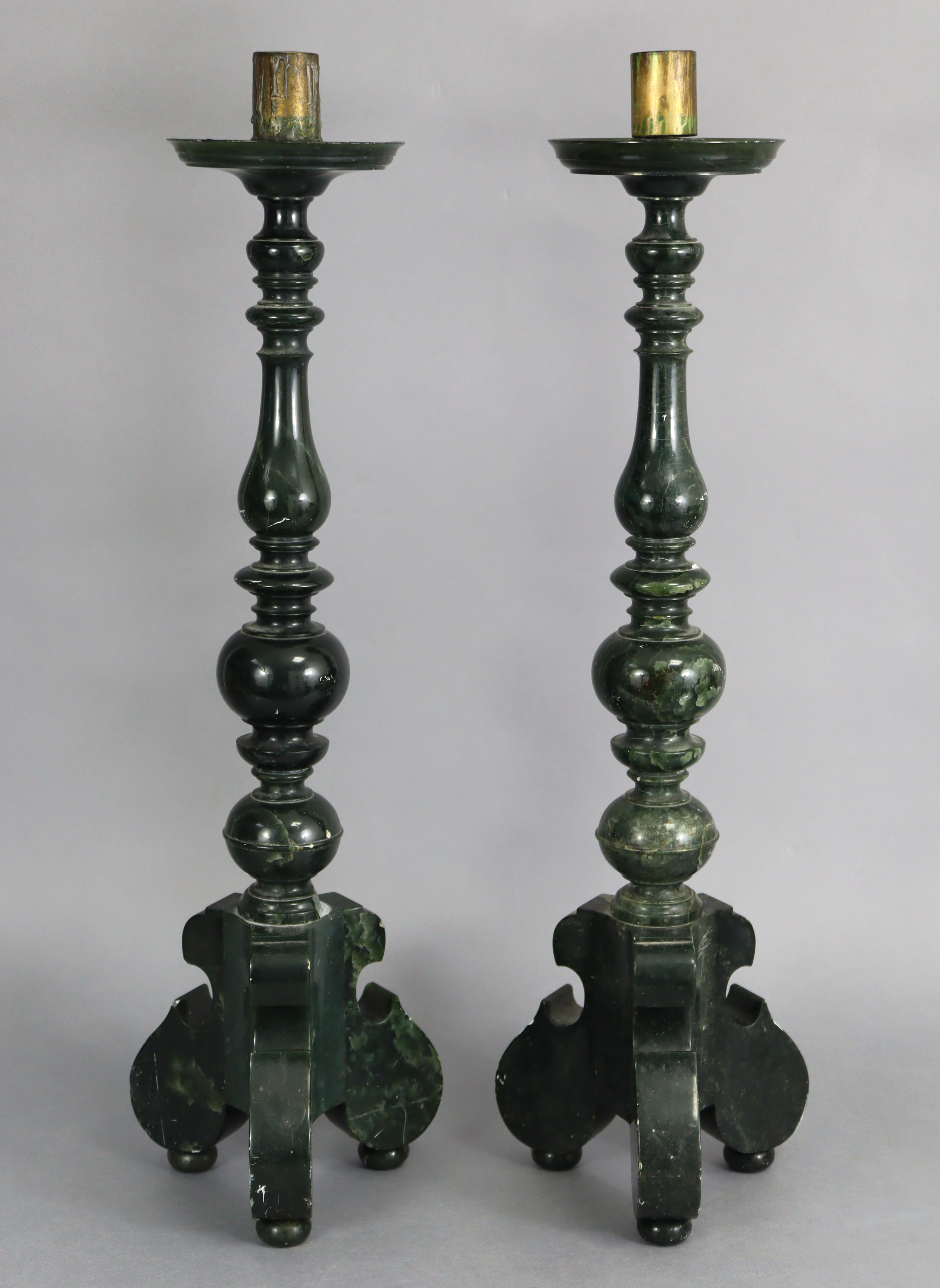 A pair of dark green soapstone altar candlesticks, the colouration resembling spinach-green jade,