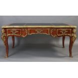 A LOUIS XV STYLE BUREAU PLAT, inset gilt tooled leather to the shaped rectangular top, with