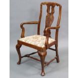 A Queen Anne style walnut armchair with shaped & pierced splat back, curved open arms, padded drop-
